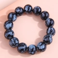 Detailed view of fashion glass bead bracelet featuring black beads with unique blue patterns - Blue and Black Spotted
