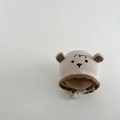 Close-up of knit texture and embroidered bear face on winter baby hat with earflaps - Beige - Sheep
