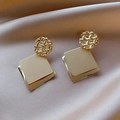 Exaggerated geometric gold square sequin earrings on soft pink silk background - Gold