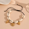 Close-up of white shell anklet with golden leaf and seashell charms on black cord - Black Rope Shell Bracelet