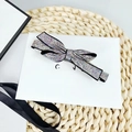 Elegant bow hair clip with colorful AB rhinestones on a minimalist display card - AB Rhinestone - Flat Corner