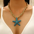 Golden woven chain necklace with textured blue starfish pendant on model - Teal Rope Blue Starfish Pendant Necklace (5150)