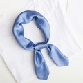 Elegant plain blue silk square scarf tied in a knot on a white minimalist background - Blue