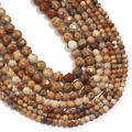 Detailed close-up of faceted natural stone beads in earthy brown and beige tones - Jasper
