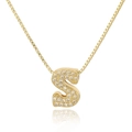 Macro shot of gold-plated S letter pendant with micro-paved zircons on a box chain - Letter S