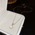 Detail shot of a silver cat eye stone necklace featuring a polished box chain in a white box - Geometric Cat's Eye Necklace