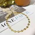 Detailed macro shot of a gold pig nose chain necklace on a lifestyle magazine background - Pig Nose Coffee Bean Chain Long Style