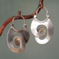 Vintage silver-plated gypsy spiral hook earrings hanging on a natural branch backdrop - Vortex Texture