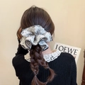Elegant oversized floral scrunchie with lace edges worn on a braided hairstyle - White Floral Scrunchie