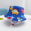 Close-up of kids dinosaur print bucket hat featuring blue fabric and adjustable chin strap - Royal Blue-Animated Dinosaur