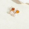 Elegant gold earrings with white pearl and amber resin bead in a double-ball stud design - Yellow