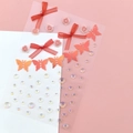 Face gem set with red ribbon bows, pink resin roses, and sparkling orange glitter butterflies - Red Flower Butterfly Gems (BJA-650)
