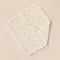 Detail of cotton baby bib with colorful polka dots, pom pom trim and handy neck strap - Colorful Dots And Beige