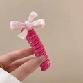 Pink bow decoration on rose red telephone wire hair tie held by hand in a simple pose - Pink [Candy Bow]