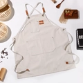 Beige heavy-duty canvas work apron with leather straps and multiple pockets for gardening - Off White