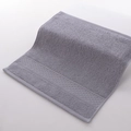 Absorbent grey cotton face towel featuring a dense loop texture and honeycomb weave border - 34x34cm / True Grey