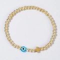 Dettaglio del bracciale con perline dorate, occhio greco blu e ciondolo a croce - Occhio Blu Chiaro-Oro (JS-B24070302B)