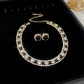 Golden necklace and earrings set with alternating black and clear zircons on black tray - Black and White Diamond Alternating / Gold-Black