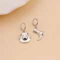 Polished silver alloy cowboy boot and hat mismatched hoop earrings on beige background - Asymmetric Cowboy Hat & Boot Earrings / Silver