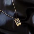 18K gold plated tarot necklace with The Star pendant on a luxury pleated fabric background - Star