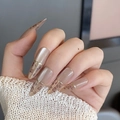 Macro detail of nude pointed press-on nails with leopard print, cat-eye effect and gold line - BY1766 Long Almond / Phototherapy Glue Style