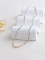 Modern geometric silver chain necklace with white freshwater pearls on display - 8 Pearls Silver Bead Necklace