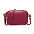Detail of burgundy leather camera bag featuring unique zigzag stitching on the strap - Red