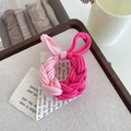 Pink and rose red woven elastic hair tie on a rustic wooden tray with vintage props - Red