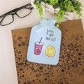 Blue mini hot water bottle with lemon cartoon pattern on a vintage book backdrop - Cup