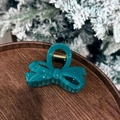 Teal bow hair claw clip displayed on a wooden tray with festive pine decor - 8cm / Irregular Bow