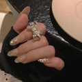 Silver bow knot ring with pavé cubic zirconia worn by model on finger - Bowknot Ring