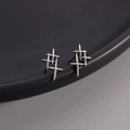 Detailed macro view of 925 sterling silver thorn earrings with sharp geometric design - Retro Star / Silver