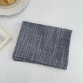 Detail of navy blue checkered linen placemat with neat stitching on a dining table - Navy Blue