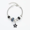 Silver snake chain bracelet with black faceted beads and a lucky clover floral pendant - Black Floral Bracelet
