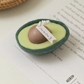 Handmade avocado-shaped scented candle with detailed realistic green texture and brown core - Avocado