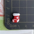 Detailed view of mini resin red Christmas stocking charm on a centimeter scale mat - 03-Snowflake Christmas Sock