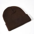 Detail view of dark brown knitted beanie with ribbed texture and cuffed design - Coffee