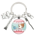 Dental-themed silver keychain featuring glass pendant and miniature tools charms - Cartoon Girl Dentist Illustration