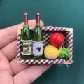Detailed macro shot of miniature wooden crate with wine bottles and fruit magnets - 2 Bottles 2 Fruits Style