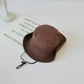 Close-up of brown outdoor sun hat with adjustable black chin strap on white table - Chestnut