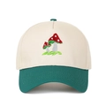 Close-up of mushroom embroidery on beige and green two-tone trucker hat with stitching - Adjustable / Dark Green