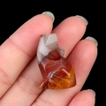 Mini hand-carved natural agate wolf figurine with translucent reddish-brown stone textures - Colored Jade