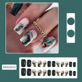 Detail of square press-on nails in emerald green and marble white with gold accents - BKS2604 Dark Green Smudge Gold Wire