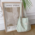Detail of green and white striped canvas tote bag against artistic home decor - Green Stripes