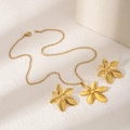 Golden jewelry set with five-petal flower necklace and matching earrings on a pedestal - Five-Petal Flower Shape Style (E2638-3)