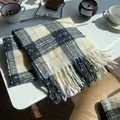 Plaid knitted scarf in cream, navy, and orange with tassels in a cozy setting - Star Tears