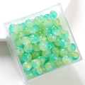 Macro view of gradient green cylindrical glass beads stored in a transparent square box - Green Series Apple Bead