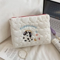 Close-up of white heart quilted makeup bag featuring Dalmatian embroidery and red zipper - Handheld Headphone Dog