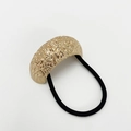 Close-up of golden hammered metal finish hair tie with black elastic cord on white background - Sand Rose Type 1