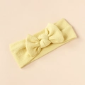 Close-up of a pale yellow textured elastic baby headband featuring a knotted bow design - Light Yellow